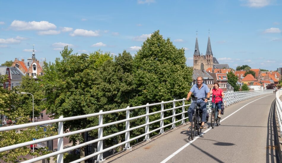 Echtpaar fiets door Deventer bij de IJsselbiënnale.